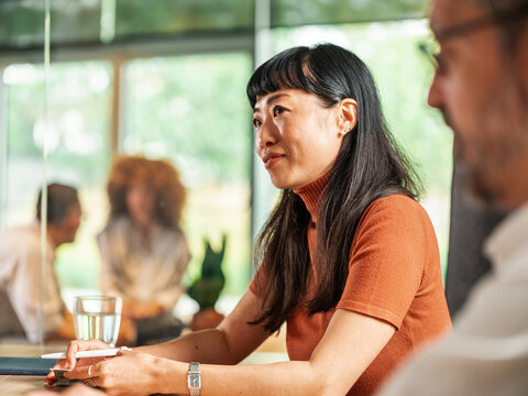 Portrait of Professional Asian Woman During Group Meeting