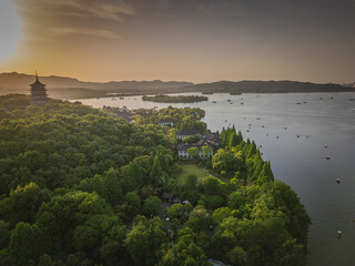 Aerial view of West Lake on left and Leifeng Tower from Wushan Hill at sunset, Xihu District, Hangzhou, Zhejiang, China