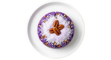 Decorated easter egg with pecans and coconut on a white plate