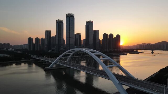 Aerial view of a modern white arch bridge spanning a river at sunset with a city skyline silhouette in the background vector illustration