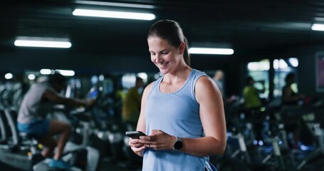 Smile, phone and woman in gym for fitness, training schedule or check stats for information. Mobile, sports club and athlete typing for online communication, text app and tracking workout for health