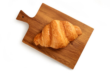 Fresh croissant on a wooden board on white background. Top view
