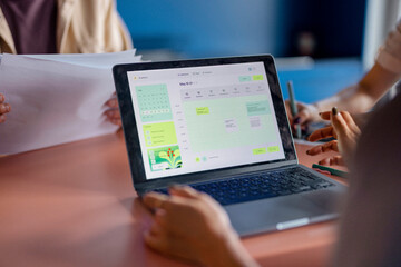 Team Working On Calendar Schedule On Laptop