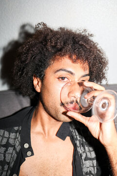 Man Enjoying Drink With a Relaxed Expression