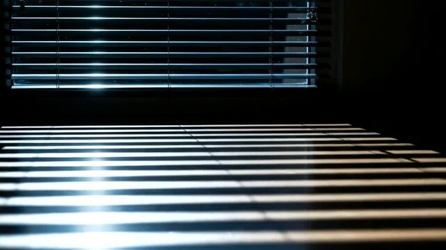 Hypnotic play of light through blinds: rhythmic patterns of illumination and shadow dancing in