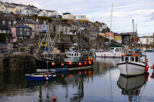 Fishing boats in  harbour. Buildings on high.