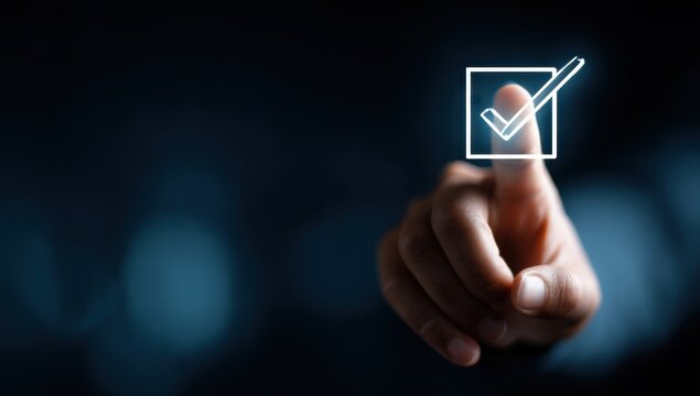 Man's finger touching a digital interface with checkmark.