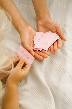 Children look at the pieces of paper with the names on them 