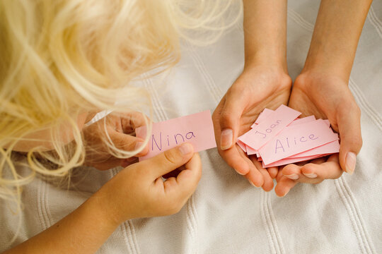 Children look at the pieces of paper with the names on them 