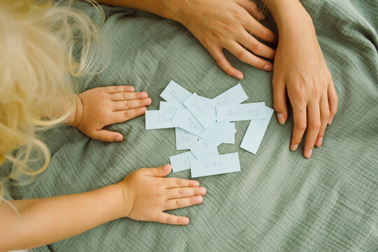 Children look at the pieces of paper with the names on them 