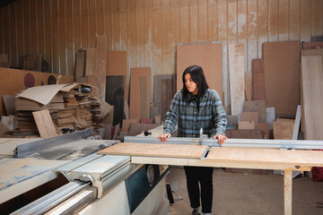 Woman Measuring Wood on Table Saw