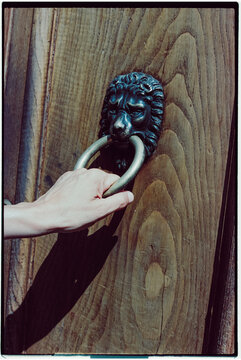 a man knocking on a wooden door in Italy, 35mm film