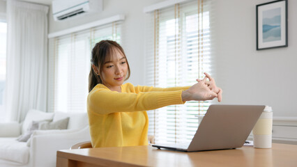 Gen Z workforce work hybrid workplace. Young adult asia people sit learn from online study class at home digital nomad stretch arm stiff neck pain yoga self care body relax stress relief break time. © ChayTee