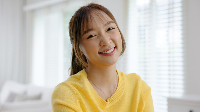 Work from home office desk asia people digital nomad young gen z teen female smile look at camera sit self relax tech talent remote career life balance happy hybrid stock trader job study learn online