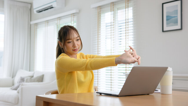 Gen Z workforce work hybrid workplace. Young adult asia people sit learn from online study class at home digital nomad stretch arm stiff neck pain yoga self care body relax stress relief break time. - Powered by Adobe