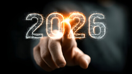 Hand interacting with a glowing digital '2026' in a futuristic interface, representing technology, future vision, business goals, and innovation.