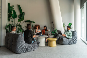 Collaborative Team Meeting in Modern Office Lounge  
