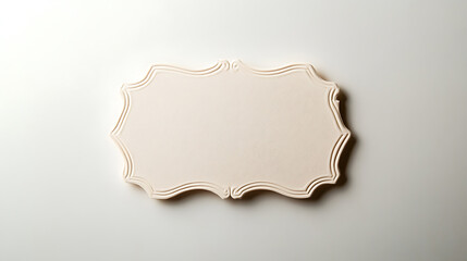 A decorative, blank label with a scalloped frame sits on a solid white surface, creating a classic and elegant presentation for personalized messages or product display.