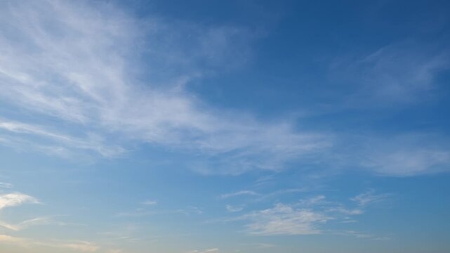 A calming blue sky timelapse featuring wispy cirrus and scattered cirrostratus clouds drifting smoothly across the frame, capturing soft daylight motion and gentle atmospheric patterns. Time-lapse.
