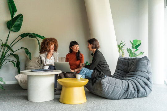 Casual Business Meeting Among Three Women  in Modern Lounge