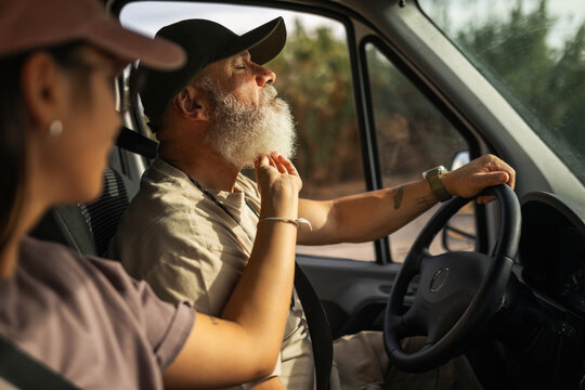 father with adult daughter traveling in a van