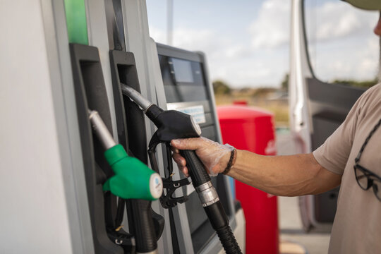 man refueling at a gas station
