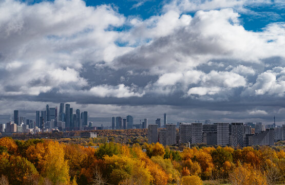 City skyline contrasts with colorful autumn trees