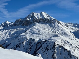 Beautiful sunlit and snow-capped alpine peaks above the Swiss village and winter resort of St. Ant&ouml;nien (St. Antoenien) - Canton of Grisons, Switzerland (Kanton Graub&uuml;nden, Schweiz)