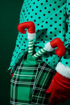 man carrying an upside-down elf tucked into his pocket