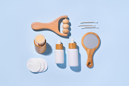 Skincare and beauty products arranged on a light blue background.