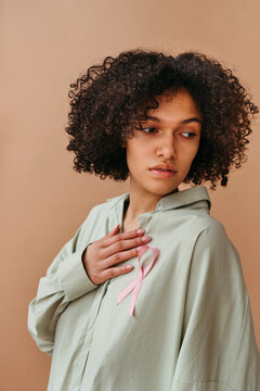 Woman Wearing a Pink Ribbon Supporting Breast Cancer Awareness