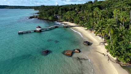 Relax on the pristine shores of Koh Kood Island in Thailand, where turquoise waters meet soft sandy beaches. Lush palm trees frame this tropical paradise, perfect for unwinding in nature.