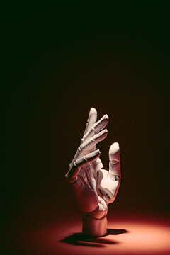 Robot hand reaching out in dark setting