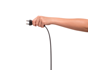 Close-up of a hand holding a black electric power cord plug isolated on transparent PNG.