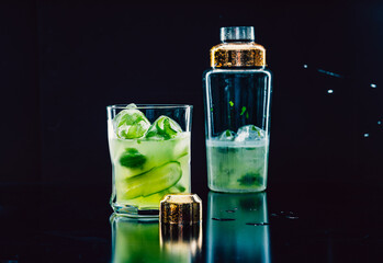 Refreshing cocktail with ingredients of cucumber slices and basil