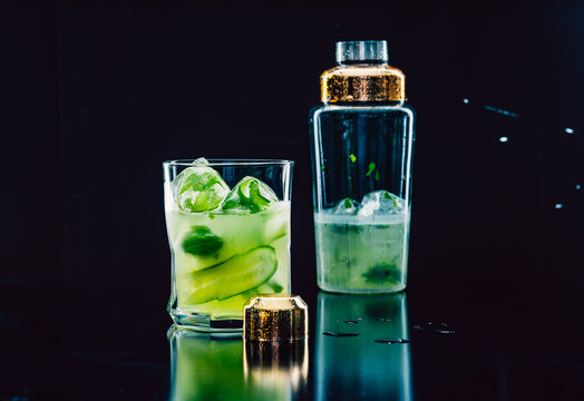 Refreshing cocktail with ingredients of cucumber slices and basil