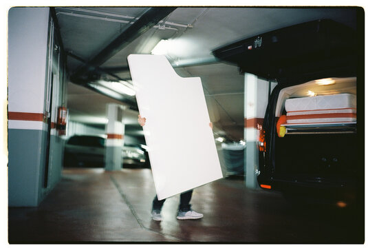 Person Carrying Large Furniture Panel