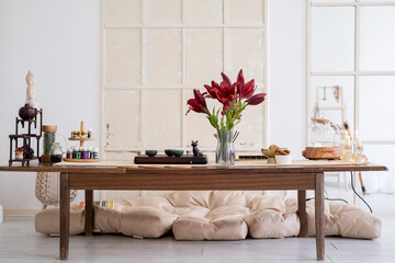 Dining room. Home atmosphere. Transparent teapot glass with tasty wholegrain snack candles bell for sound oil aromatherapy flower placed on table.