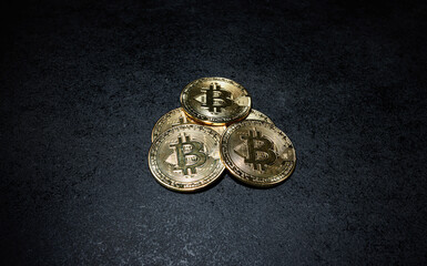 Pile of Gold Bitcoin Coins on Dark Textured Surface Stacked Shiny Bitcoin Tokens Arranged on Black Background