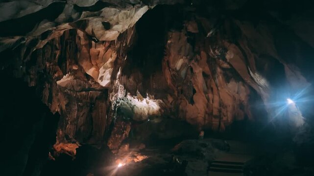 Wang Vieng, Laos.Tham Jang Cave-stalactites and stalagmites in a karst mountain with a Buddha temple inside. There is a spring inside the cave. The cave is equipped with comfortable paths and lanterns