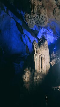 Wang Vieng, Laos.Tham Jang Cave-stalactites and stalagmites in a karst mountain with a Buddha temple inside. There is a spring inside the cave. The cave is equipped with comfortable paths and lanterns