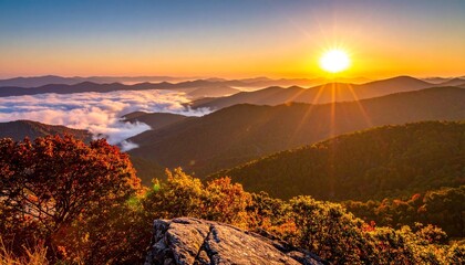 Majestic view of a mountain range at sunrise, featuring clouds, sunlight and vibrant colors