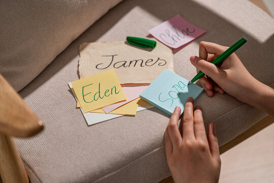 Colorful notes with baby name ideas written on a chair