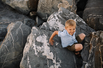 Child exploring rocks on a sunny day