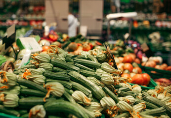 Fresh zucchini and vegetables at a market stall