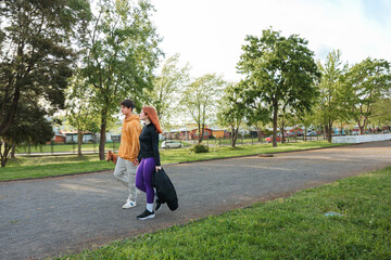 Young Couple Walking in the Park on a Sunny Morning