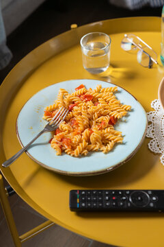 Delicious Pasta on a Yellow Table in a Cozy Living Room Setup