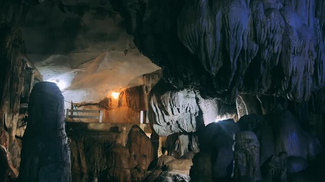 Wang Vieng, Laos.Tham Jang Cave-stalactites and stalagmites in a karst mountain with a Buddha temple inside. There is a spring inside the cave. The cave is equipped with comfortable paths and lanterns