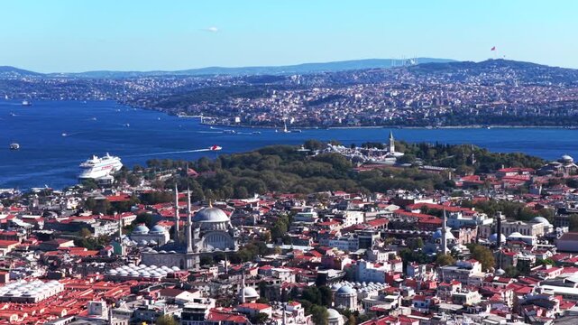 Morning Istanbul Turkey T&uuml;rkiye aerial drone the Golden Horn Blue Mosque temple Hagia Sophia Grand Mosque cityscape Bosphorus Strait river ferries boats harbor view blue sky pan right motion