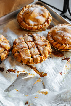 Freshly baked mini pies on parchment paper